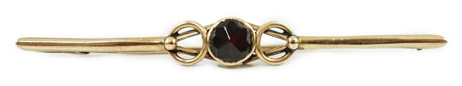 A late 19th century Russian August Wilhelm Holstrom for Fabergé 56 zolotnik gold and single stone garnet set bar brooch